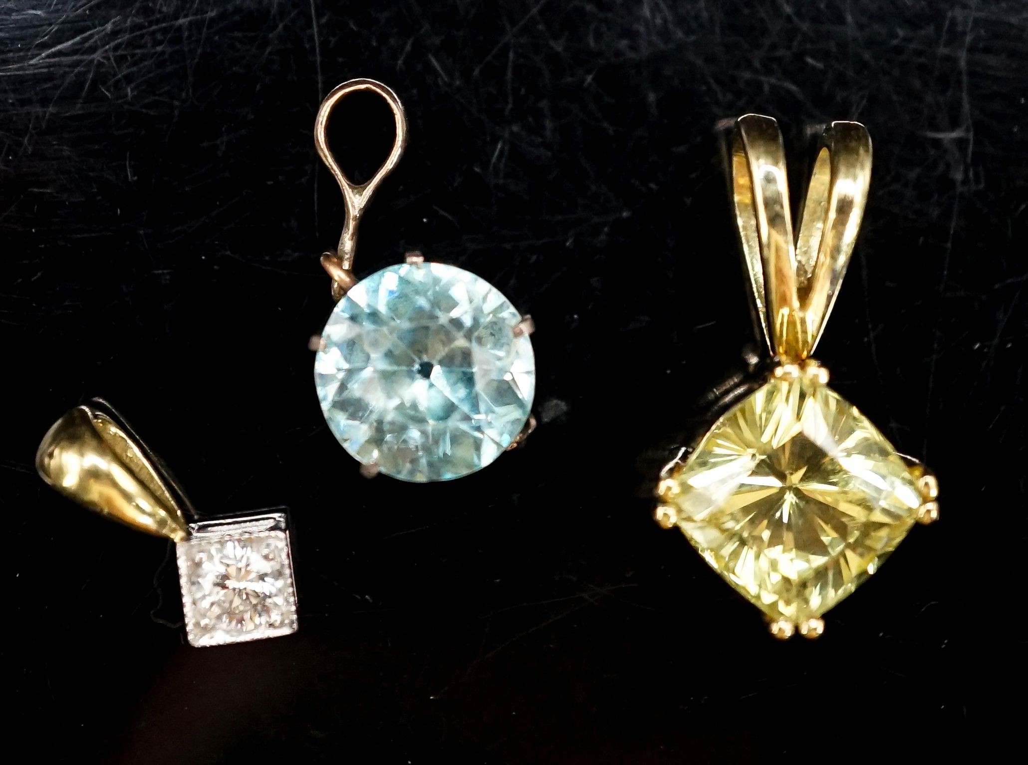 An 18ct and diamond set pendant, overall 14mm and two other gem set pendants, gross 6.5 grams,.
